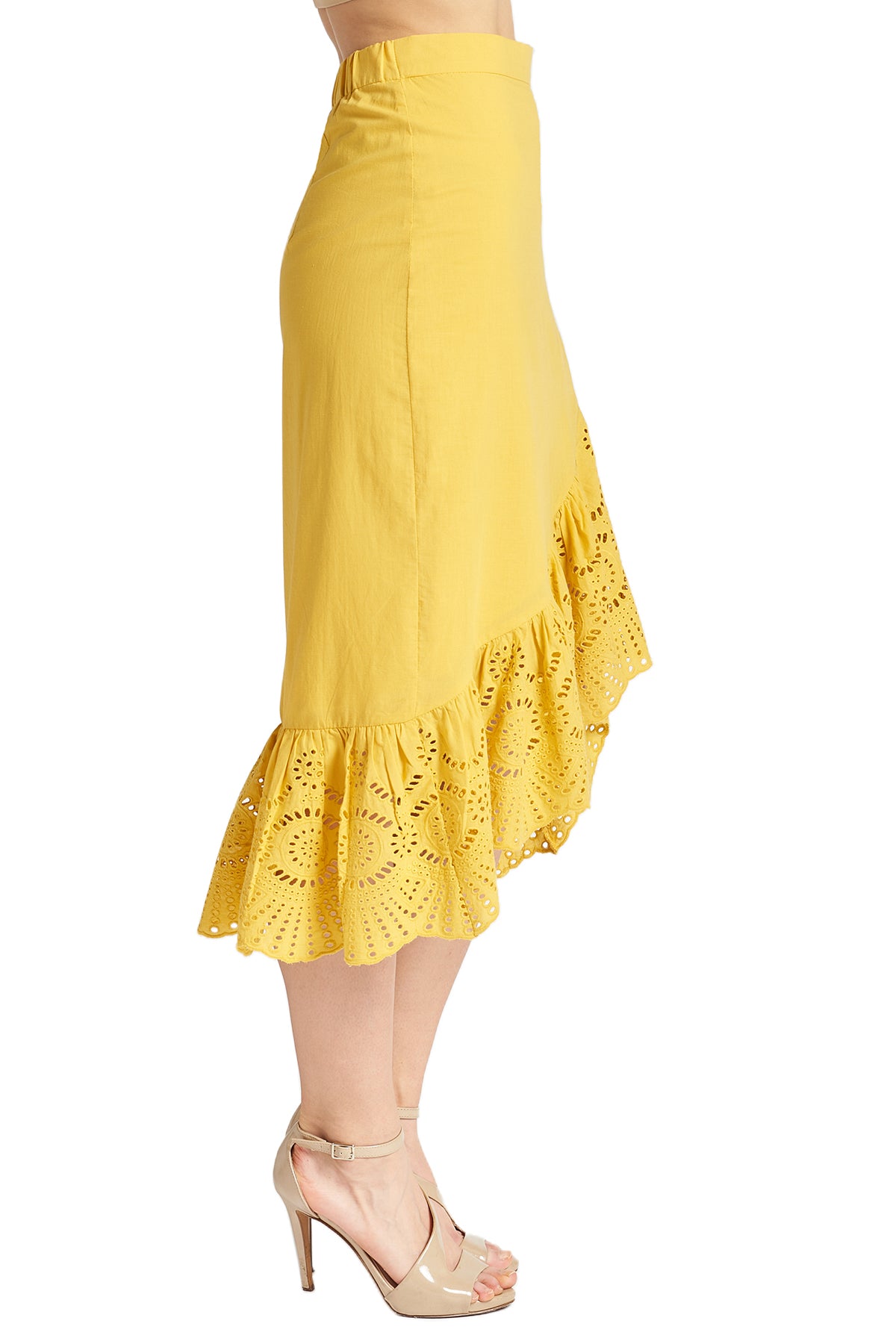 Side view of model wearing yellow cotton eyelet asymmetric ruffle hem skirt.