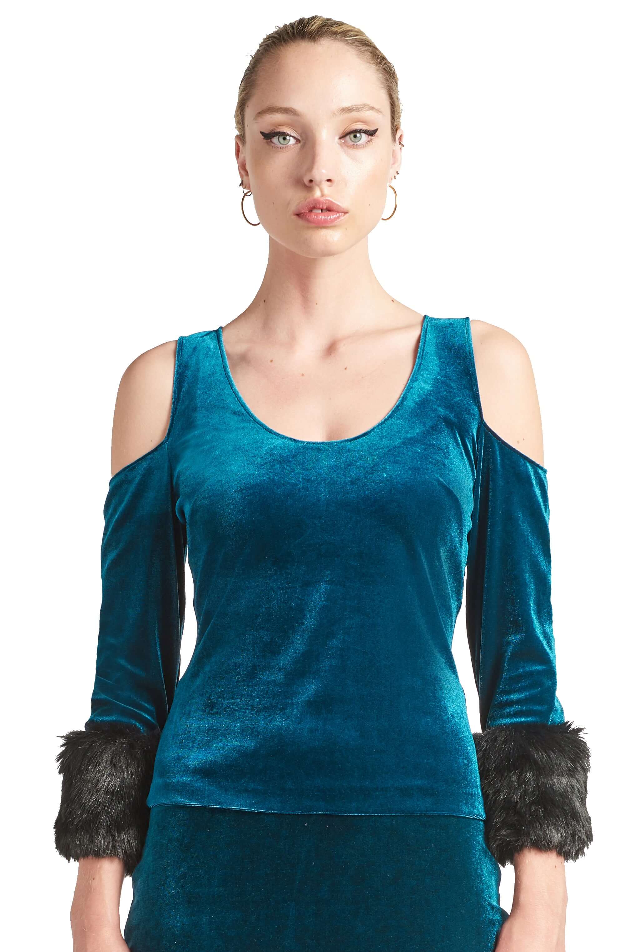 Front view of model wearing the Simona Maghen Mia Top, teal stretch velvet cut-out cold shoulder top with u-neckline, 3/4 sleeves and black faux fur cuffs.