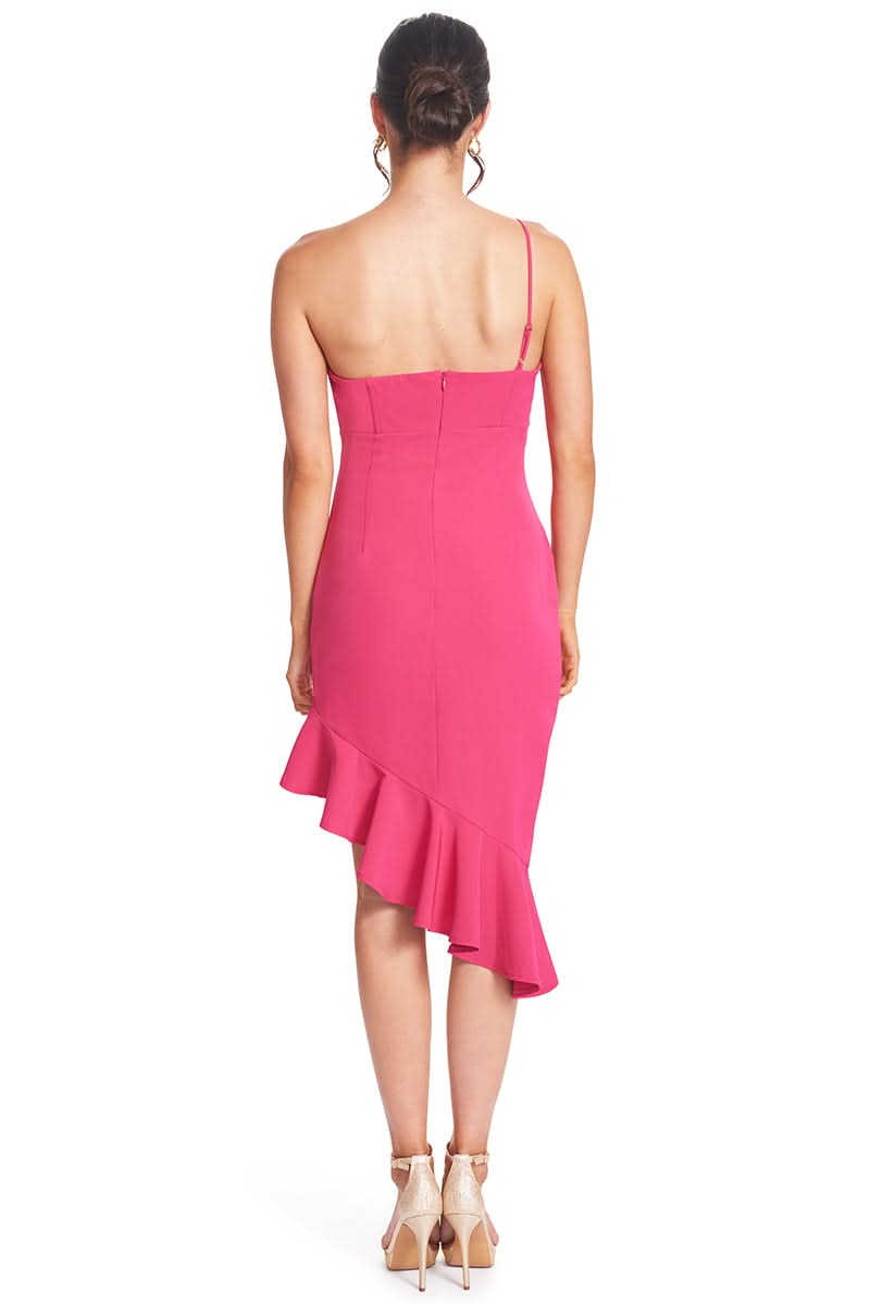 Back view of a fuchsia, one-shoulder dress with adjustable strap and ruffle hem.