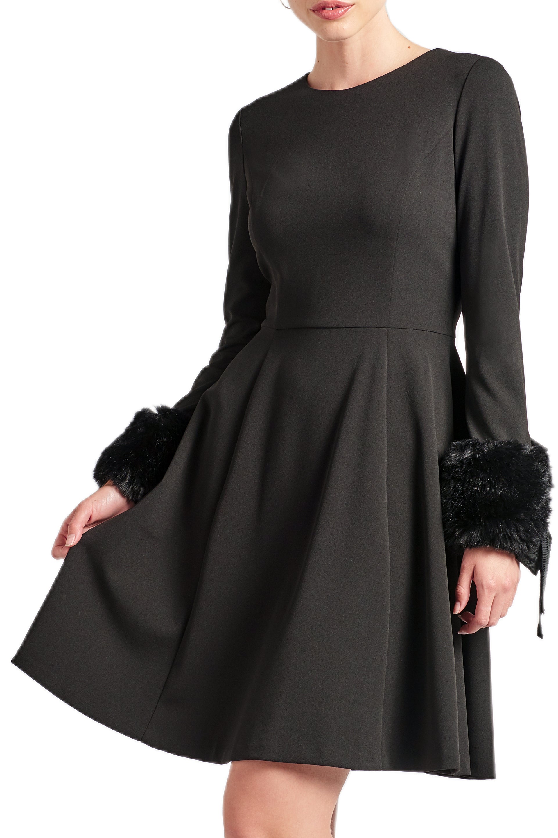 Model wearing fit & flare black poly crepe long sleeve dress with sweetheart neckline & faux fur cuffs.