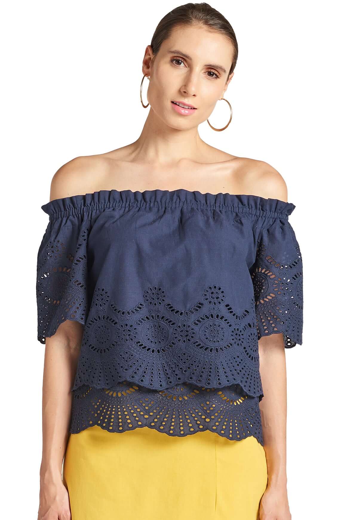 Model wearing navy off the shoulder cotton eyelet top with scalloped short sleeves and scalloped bottom hem.
