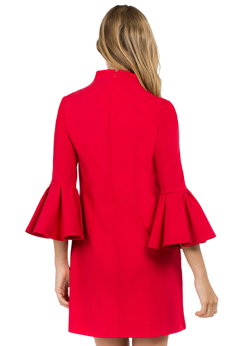 Back view of model wearing red knit Ponte mini shift dress with v-neckline, 3/4 bell sleeves and side slit pockets.