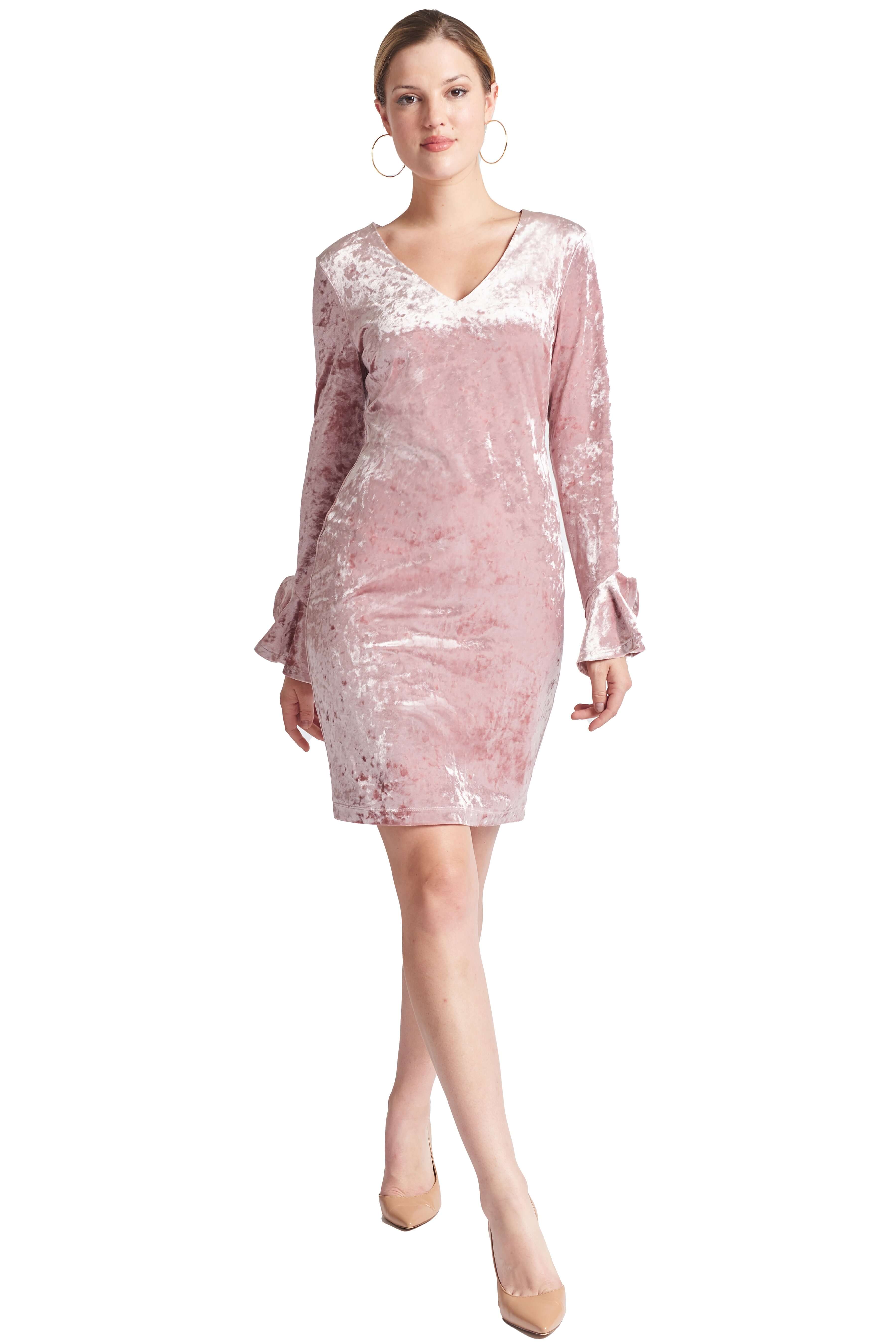 Front view of model wearing the Simona Maghen Kara Dress, blush pink stretch velvet short dress with v-neckline, long sleeves & bell sleeves.