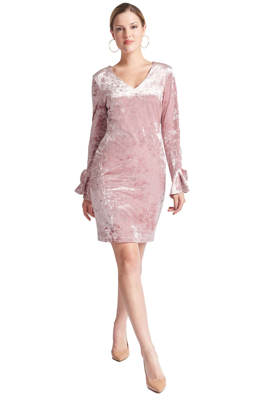 Front view of model wearing the Simona Maghen Kara Dress, blush pink stretch velvet short dress with v-neckline, long sleeves & bell sleeves.