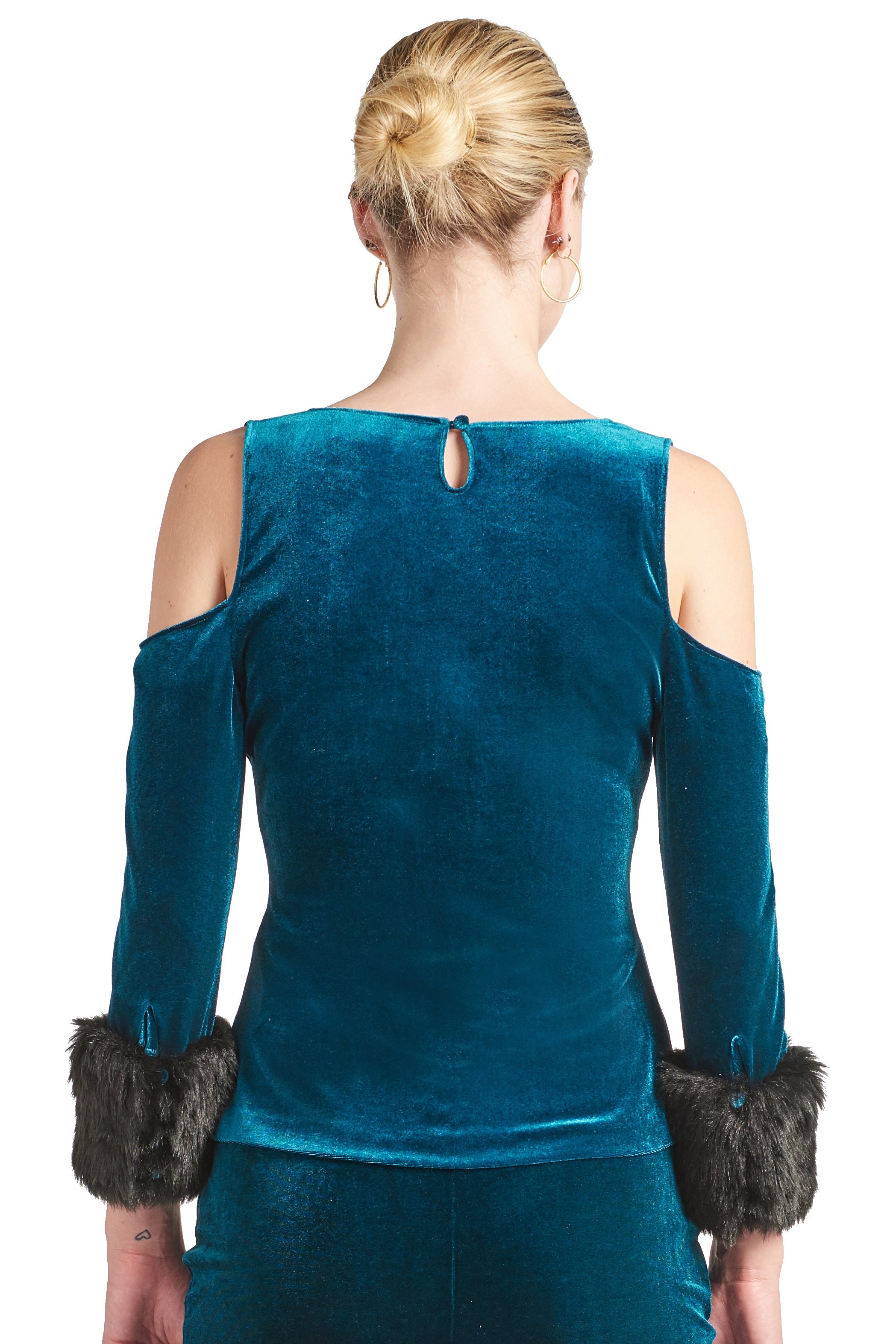 Back view of model wearing the Simona Maghen Mia Top, teal stretch velvet cut-out cold shoulder top with u-neckline, 3/4 sleeves and black faux fur cuffs.