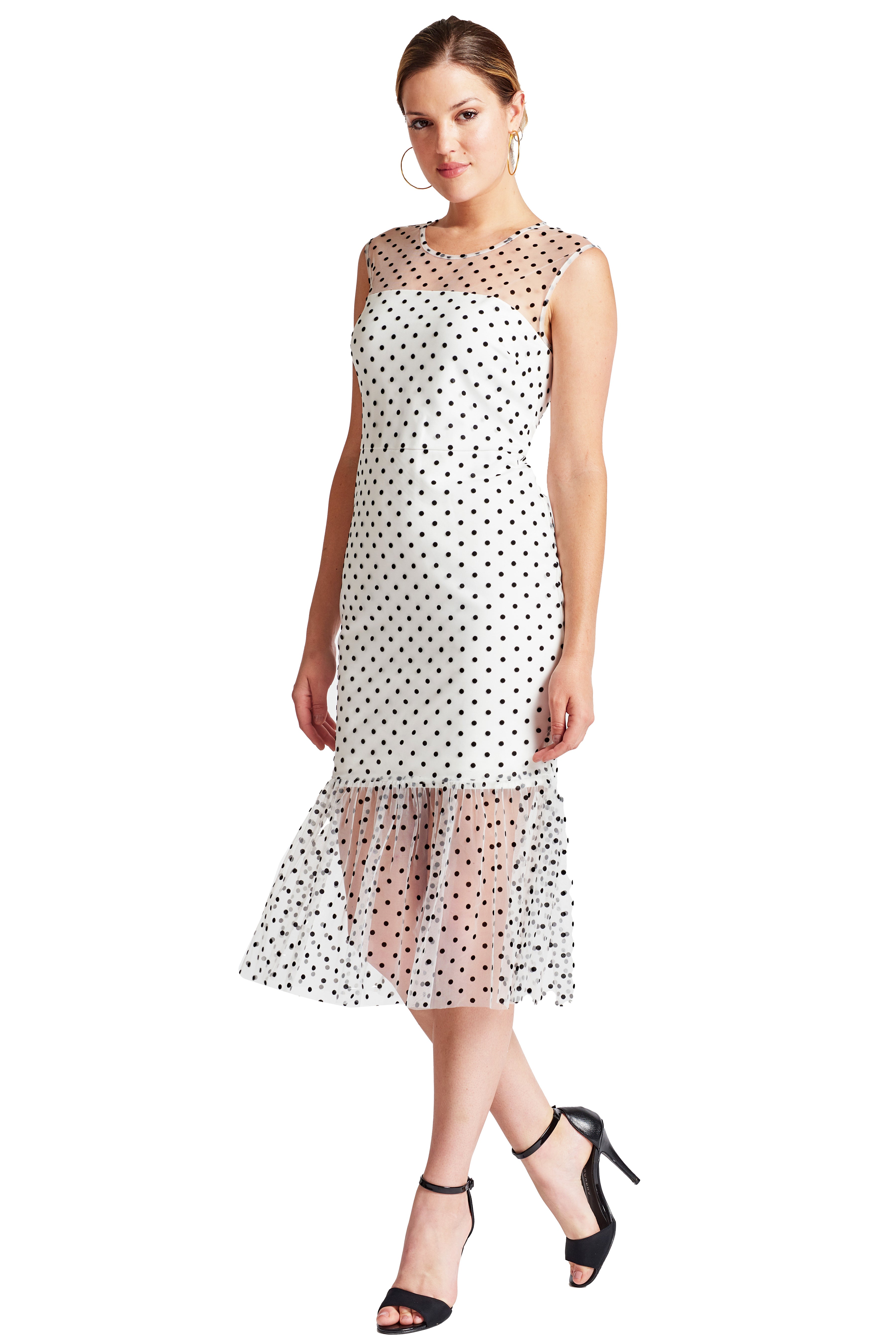 3/4 front view of model wearing the Simona Maghen Muse dress, white mesh with black polka dots sleeveless midi dress with sheer ruffle hem and round neckline.