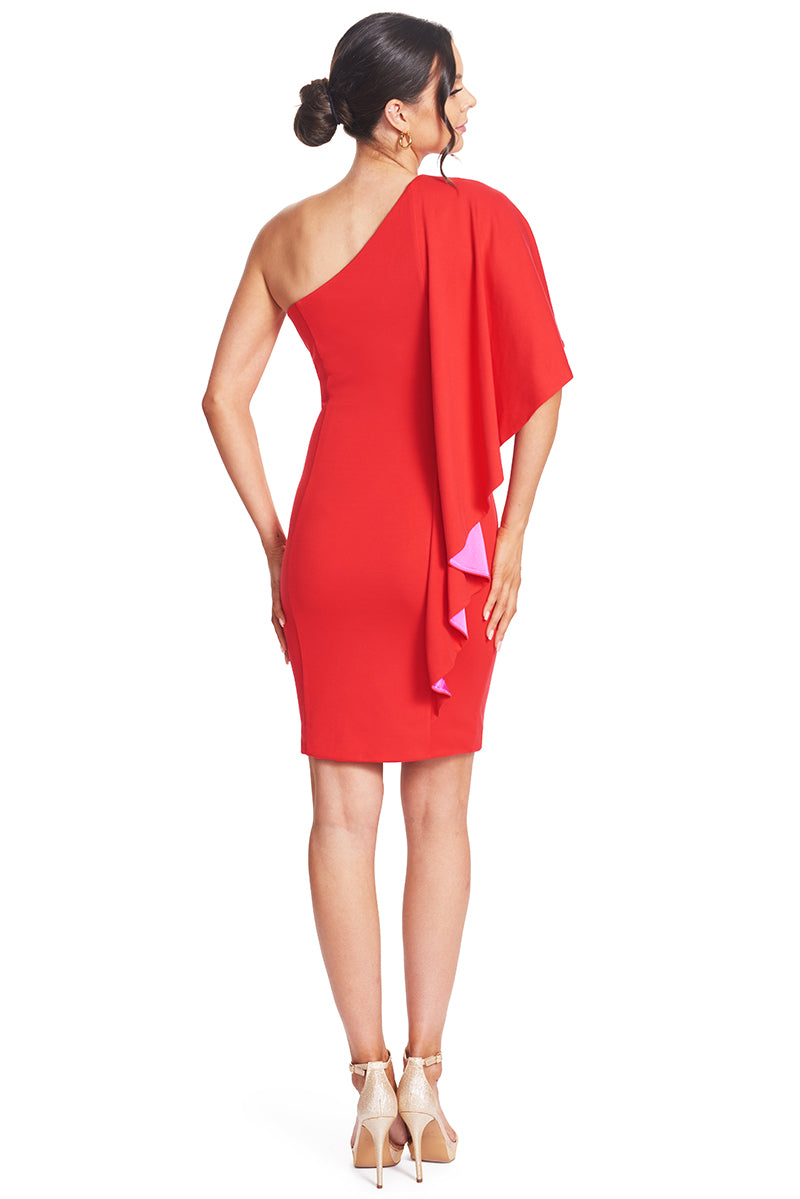 Back view of model wearing  the Simona Maghen Shero Dress, red above the knee body-con Ponte asymmetric cape dress with fuchsia contrast satin inside cape.