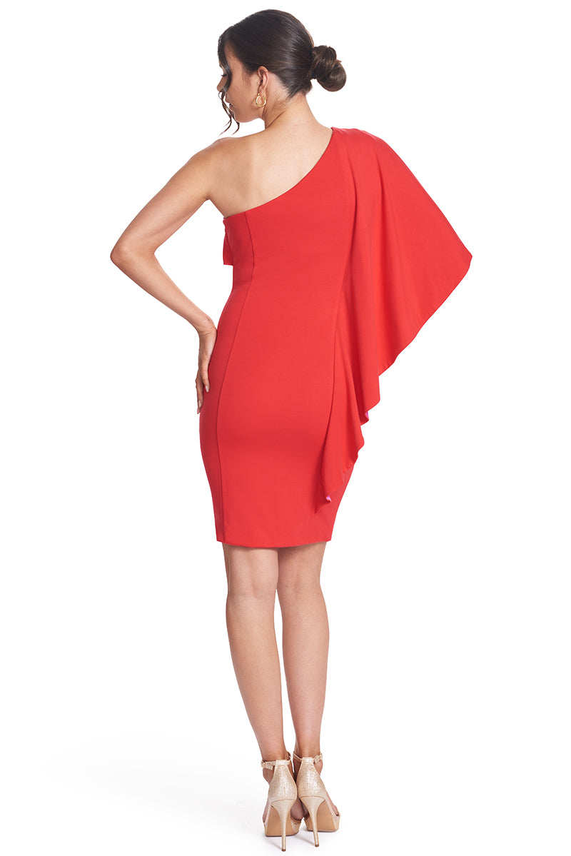 Back view of model wearing  the Simona Maghen Shero Dress, red above the knee body-con Ponte asymmetric cape dress with fuchsia contrast satin inside cape.