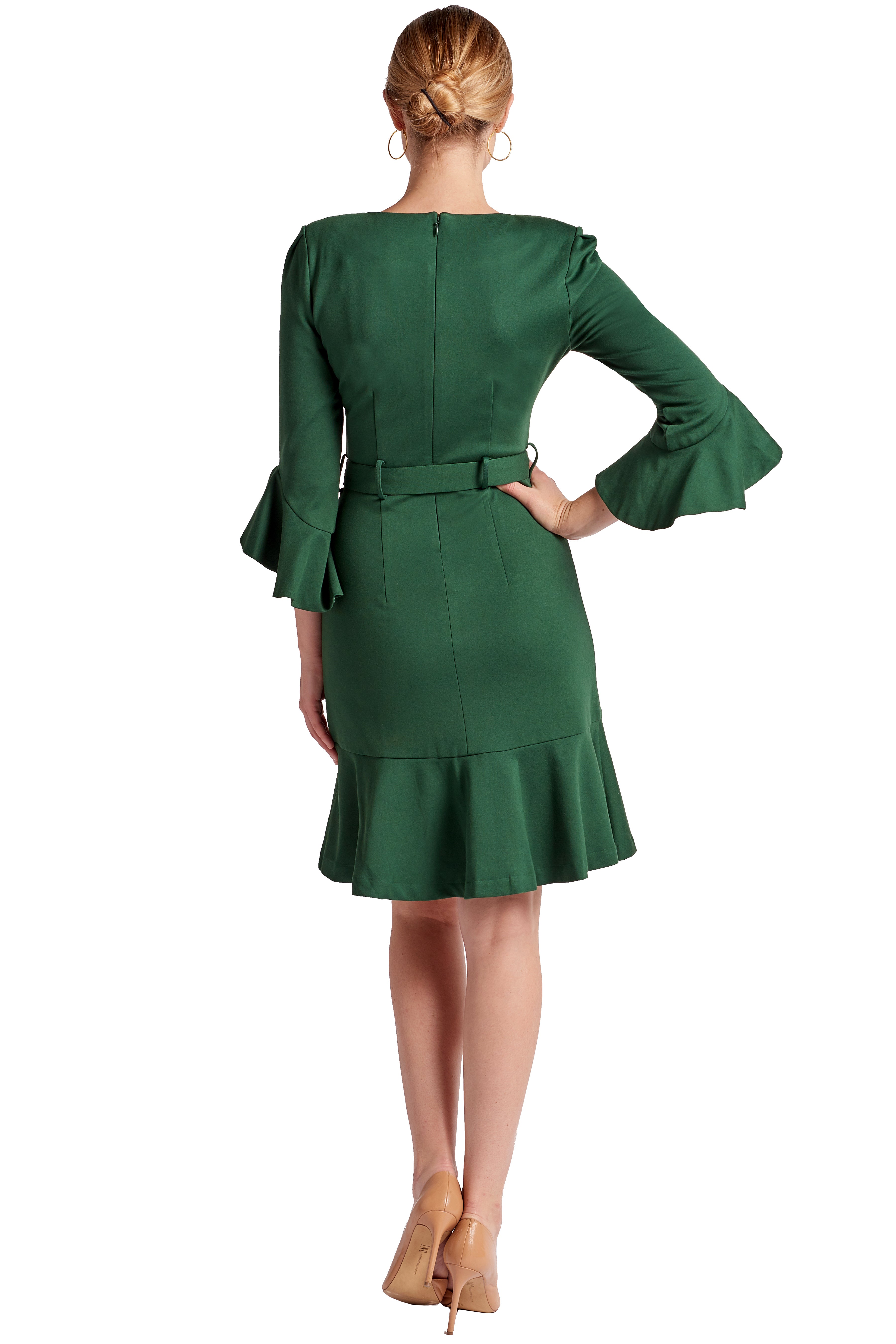 Back view of model wearing the Simona Maghen Tayte Dress in forest green, knee length, v-neck knit Ponte dress with 3/4 bell sleeves, ruffle hem and self belt.