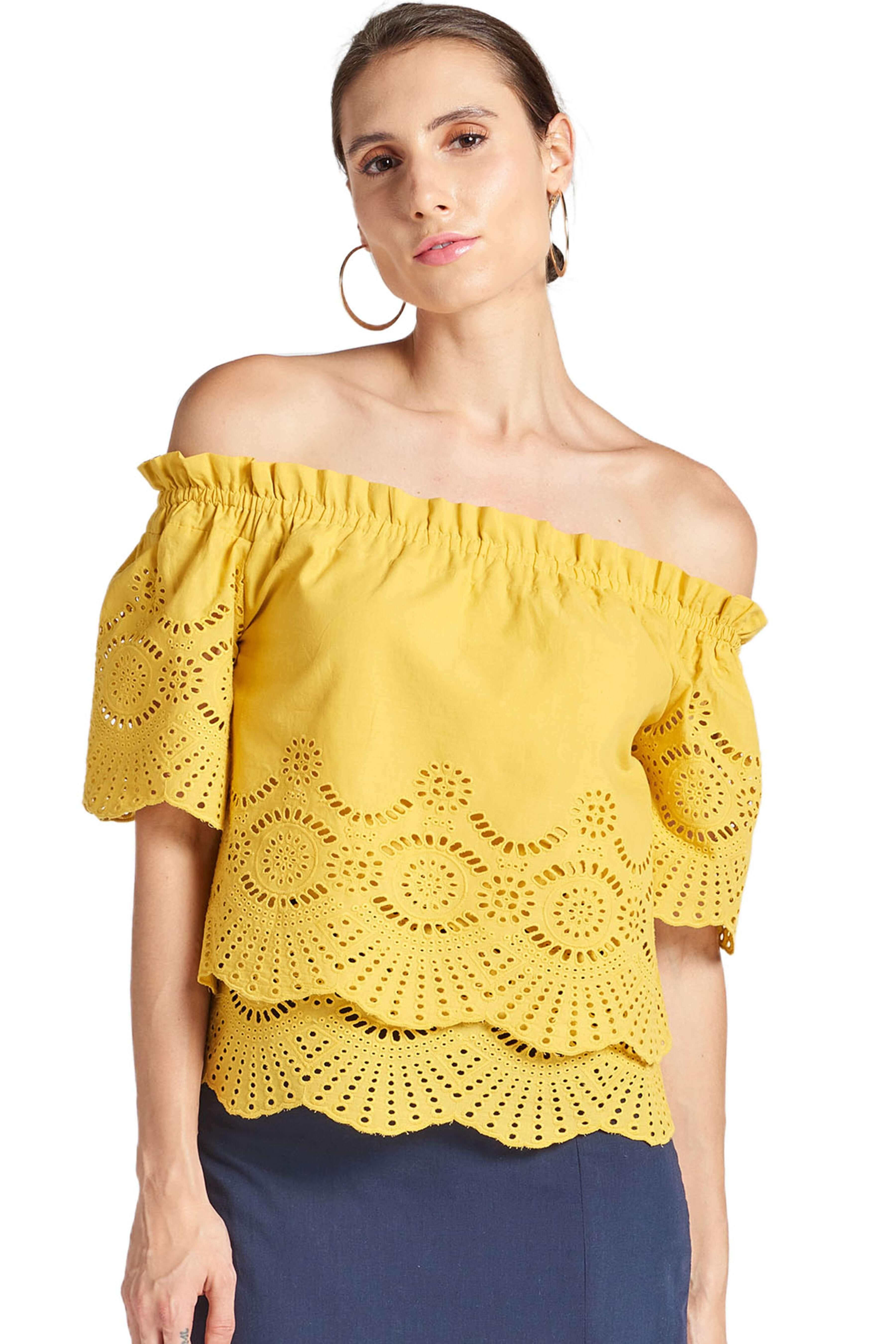 Model wearing yellow off the shoulder cotton eyelet top with scalloped short sleeves and scalloped bottom hems.